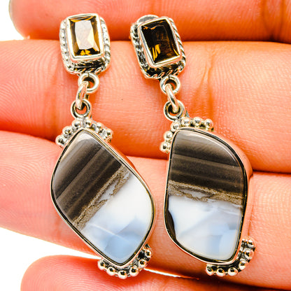 Sterling silver teardrop earrings with iridescent moonstone-like stones and dangling chains