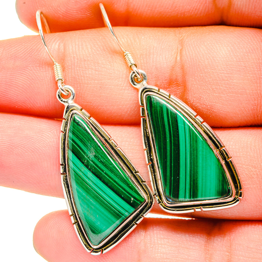 Malachite drop earrings close-up: green striped triangular stones in silver bezels