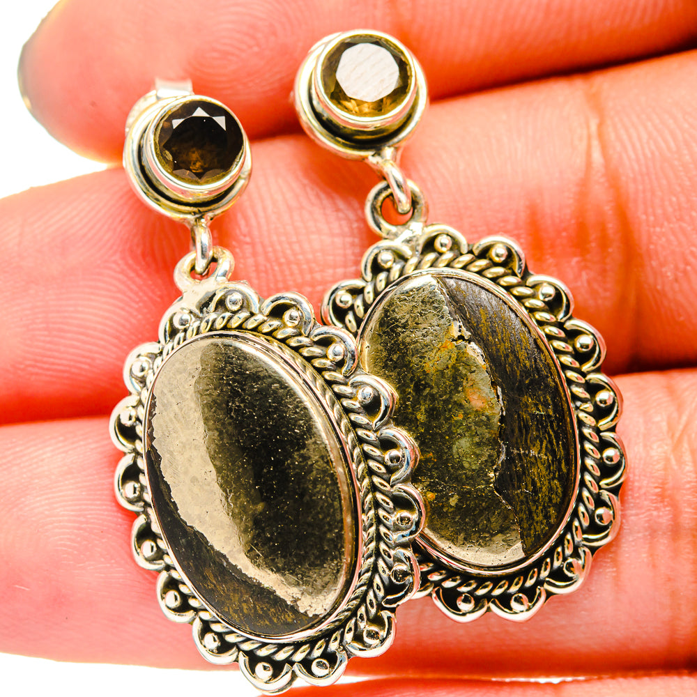 Pyrite agate oval drop earring close-up with silver filigree and gold flecks