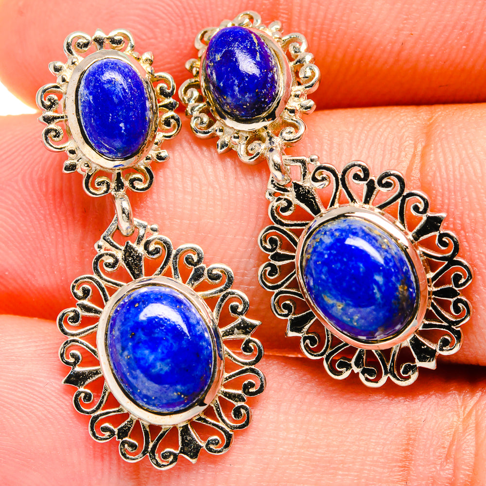 Lapis lazuli chandelier earrings with three blue oval stones and intricate gold-tone frames