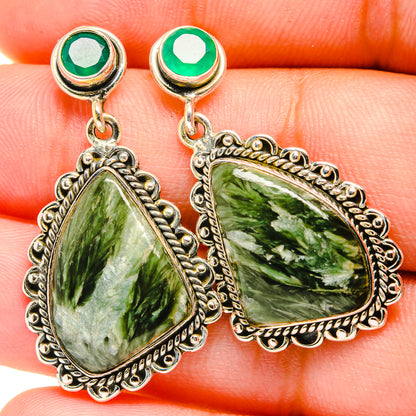 Green teardrop gemstone drop earrings with ornate silver-tone settings