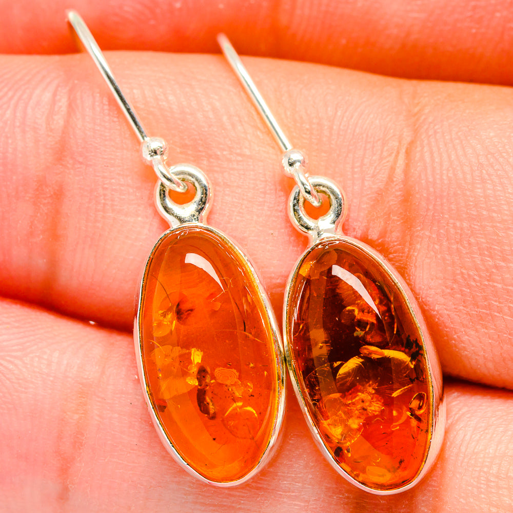 Amber teardrop dangle earrings with sterling silver hooks and oval settings