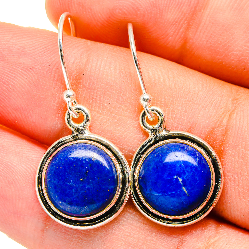 Lapis lazuli round earrings with silver hooks and bezel settings, blue stones in close-up