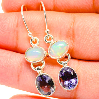 Sterling silver drop earrings with oval opal tops and oval faceted purple stones