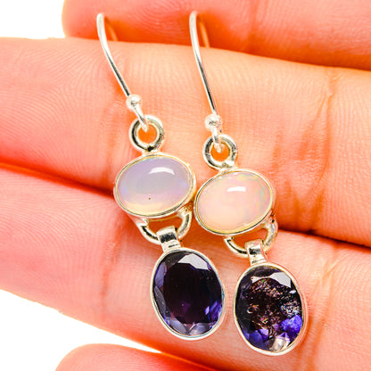 Sterling silver drop earrings with opal-like light pink and faceted dark purple stones