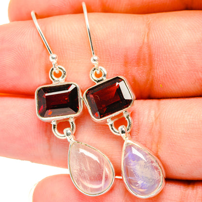 Sterling silver earrings with faceted square red garnet and pear rainbow moonstone dangles