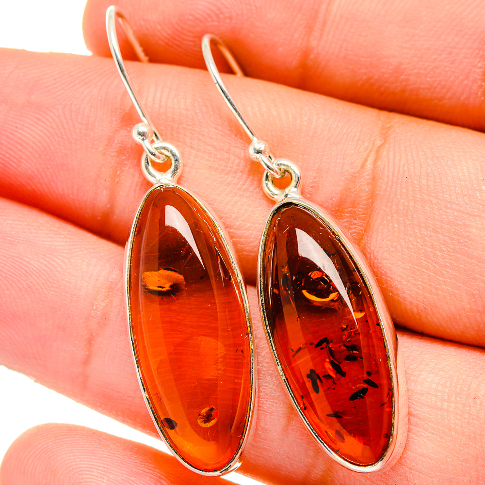 Oval amber drop earrings with 925 sterling silver hooks, amber detail visible