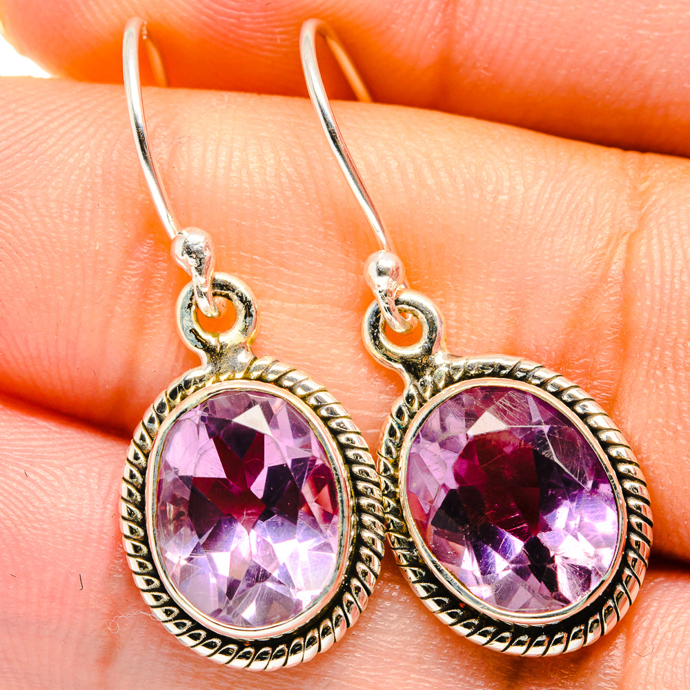 Closeup of round faceted amethyst earrings, 925 sterling silver hooks and bezel