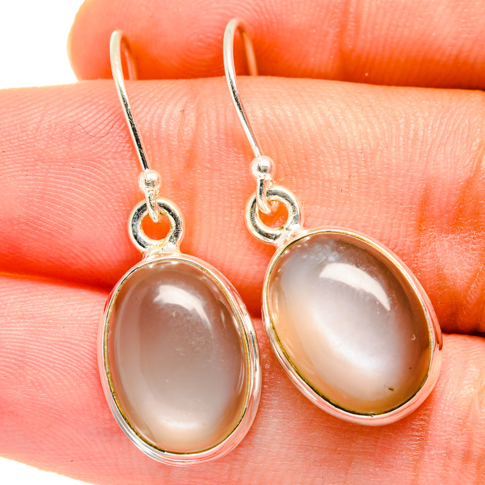 Oval moonstone drop earrings in sterling silver, pale peach cabochons, with hooks