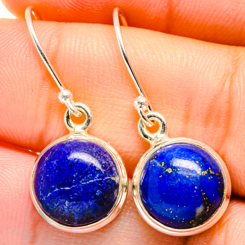 Round blue lapis lazuli cabochon earrings with sterling silver hooks.