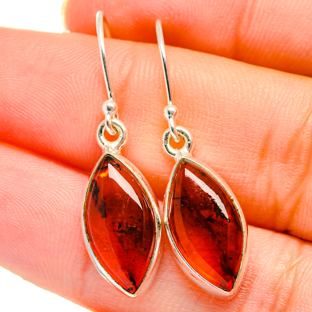 Amber marquise drop earrings in silver settings, close-up with fishhook wires