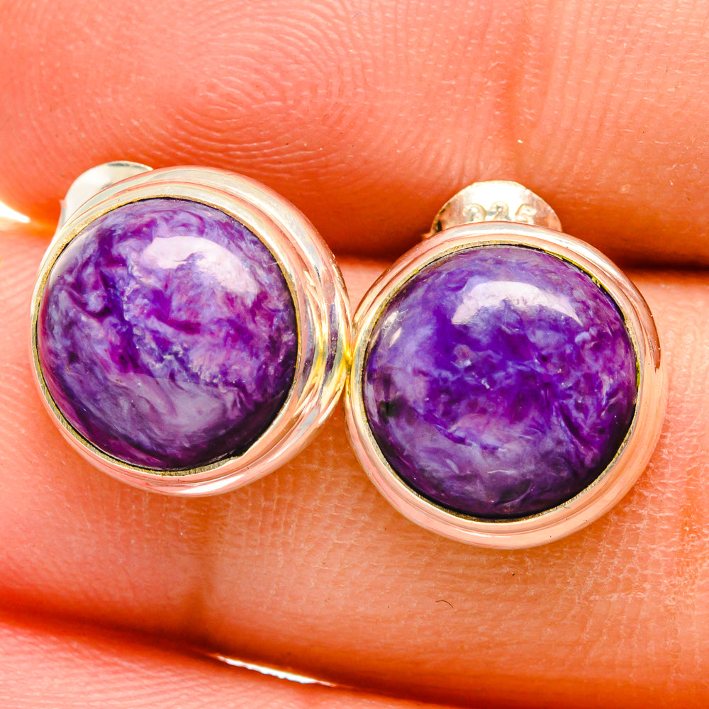 Charoite earrings close-up: round purple cabochon in silver bezel with stud posts