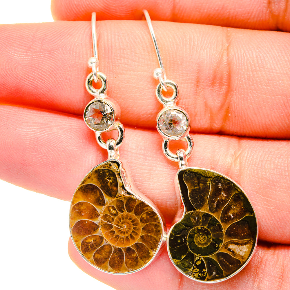 Sterling silver drop earrings with clear round stones and orange ammonite fossil dangles