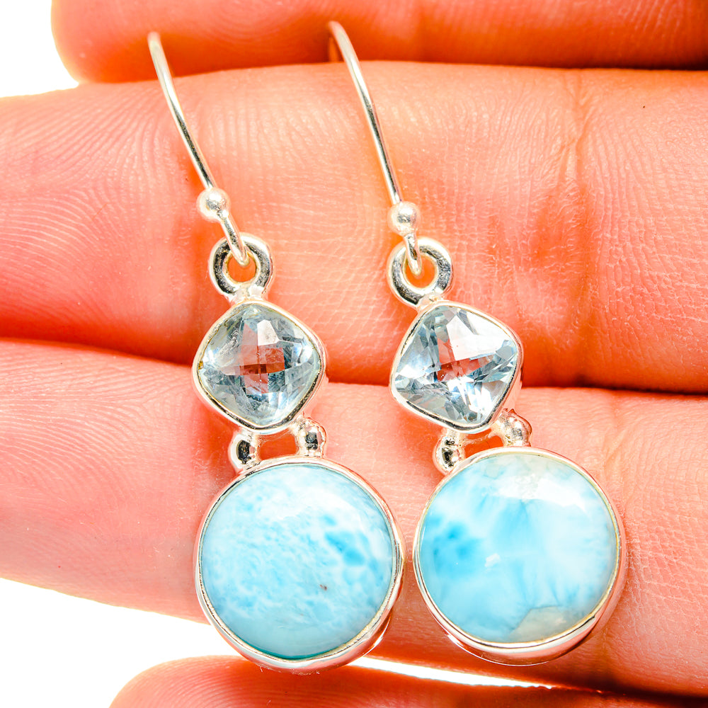 Sterling silver drop earrings close-up with blue topaz and round larimar cabochons