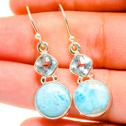 Sterling silver drop earrings close-up with blue topaz and round larimar cabochons