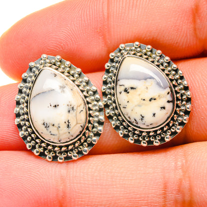 Dendritic opal stud earrings close-up, oval teardrop opal in silver bead trim
