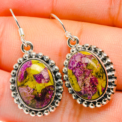 Close-up oval 925 sterling silver earrings with purple, yellow gemstone center and hook