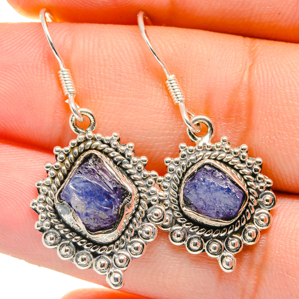 Close-up of rough tanzanite teardrop earrings, 925 silver ornate frames and hooks