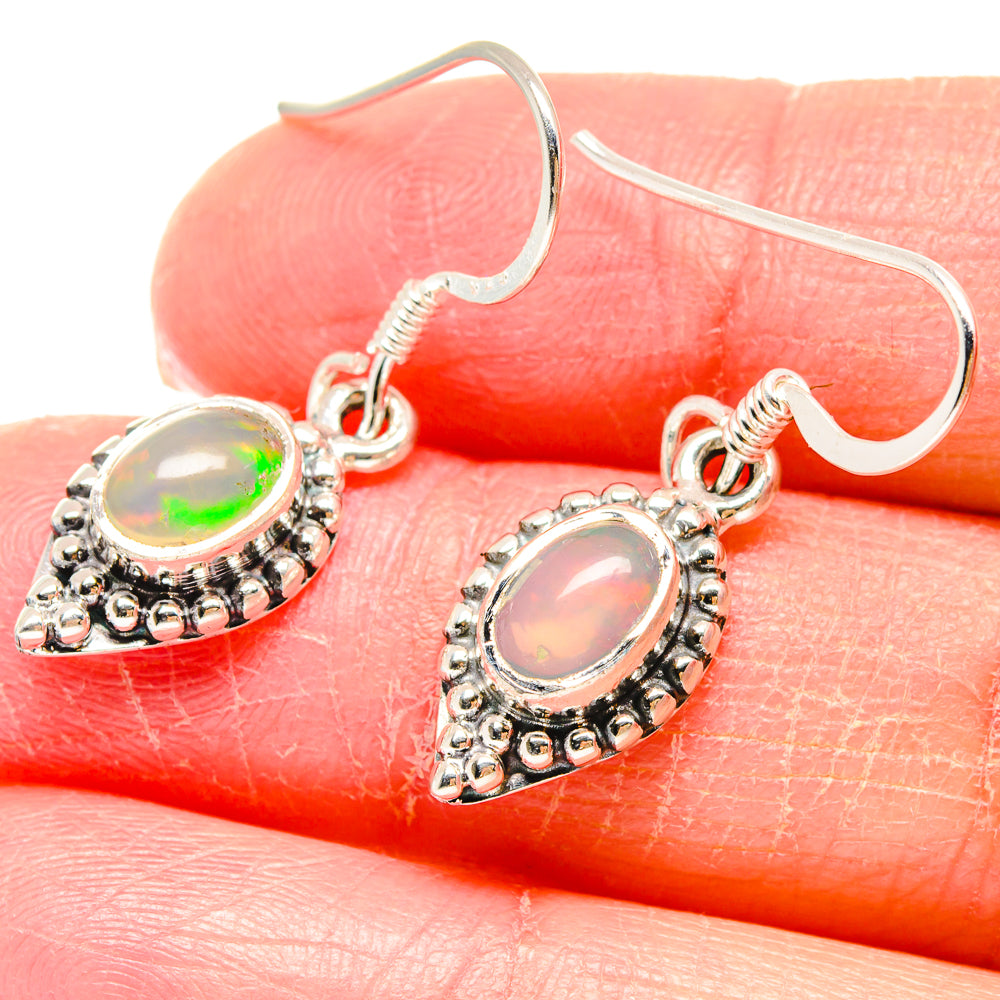 Sterling silver opal drop earrings with multicolor oval stone bezel and hook backs