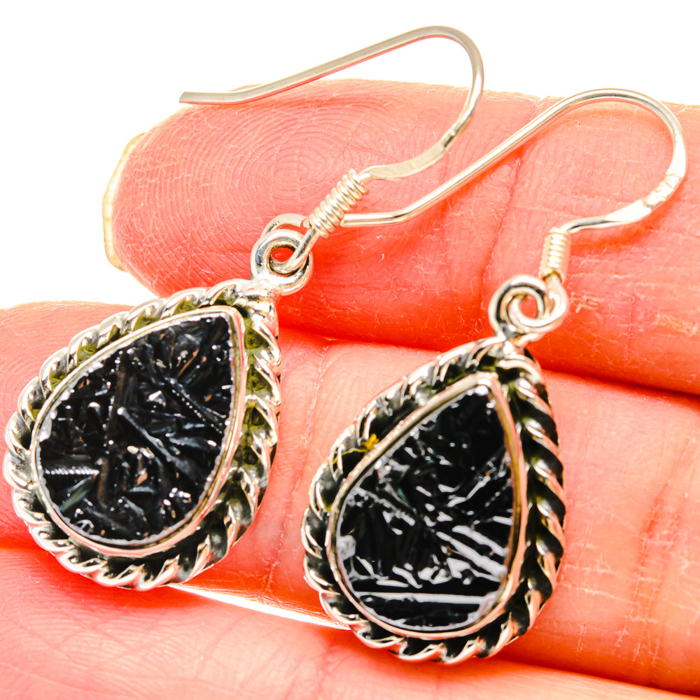 Textured silver dangle earrings with dark rough oval stones on fishhook wires