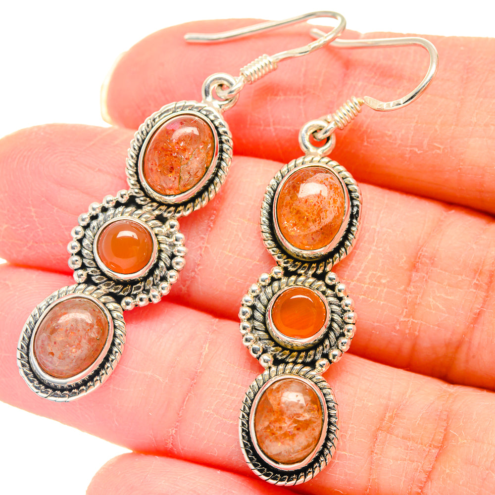 Sterling silver drop earrings with orange sunstone cabochons and beaded settings