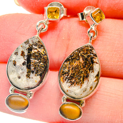 Closeup teardrop gemstone drop earrings in silver with amber oval and square yellow tops
