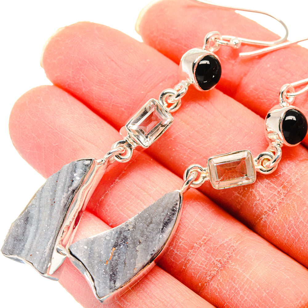 Dangle earrings with silver hooks, black onyx rounds, and druzy quartz geometric drops