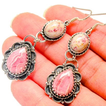 Sterling silver dangle earrings with pink speckled oval stones and pink teardrop cabochons.