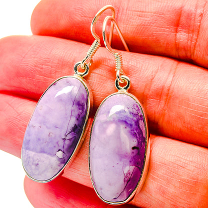 Sterling silver drop earrings featuring oval lavender-purple stone settings