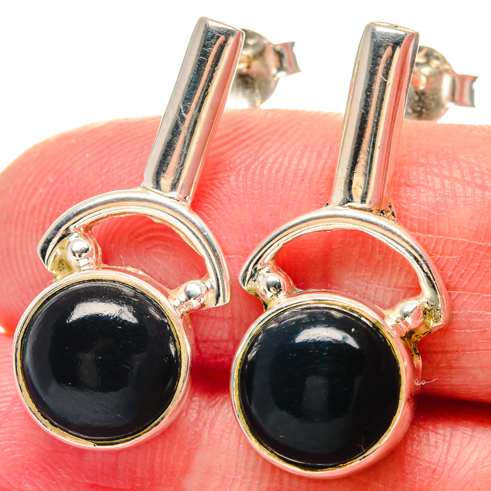 Close-up: 925 sterling silver earrings with round black onyx cabochon bezels