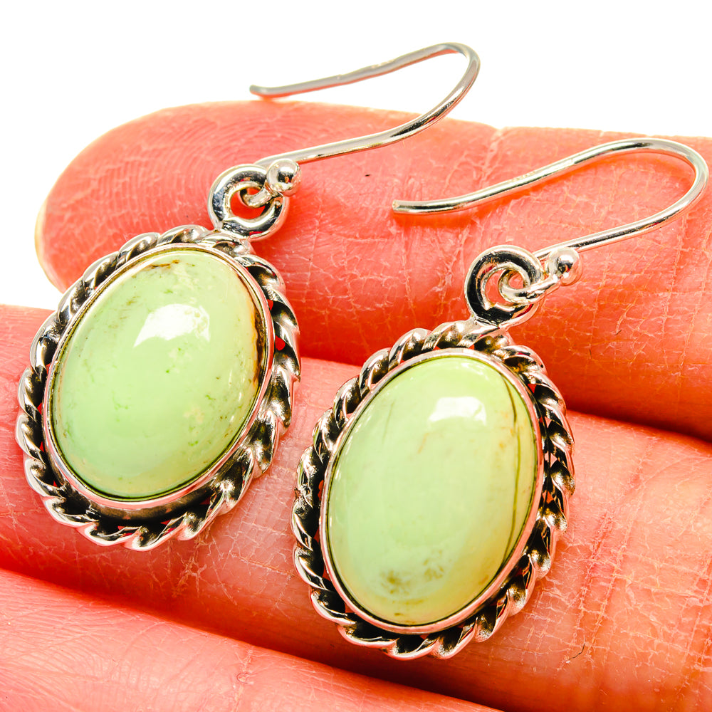 Oval green gemstone fishhook earrings in 925 sterling silver with ornate scalloped bezels