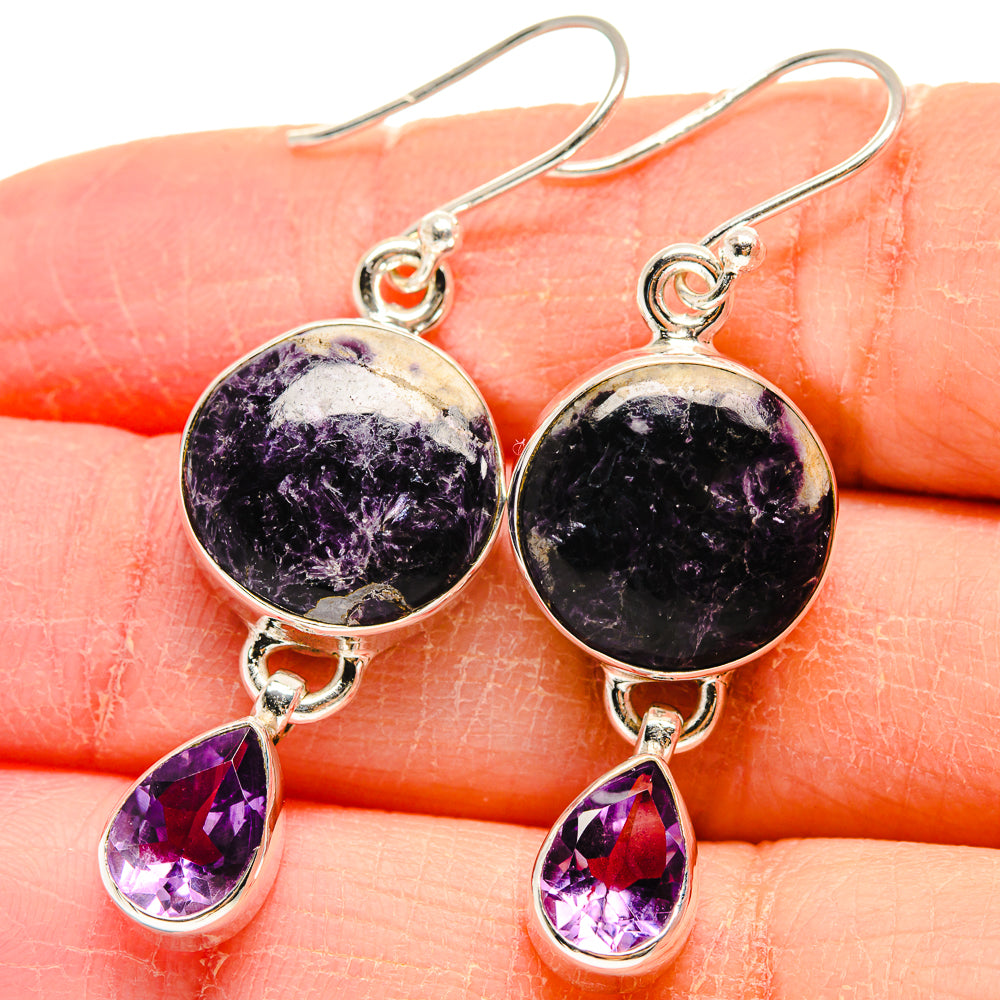 Sterling silver amethyst earrings close-up: round purple cabochon and teardrop stones