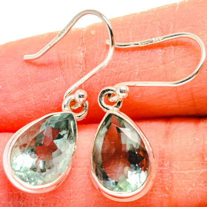 Sterling silver hoop earrings with blue-green teardrop fluorite stones, faceted