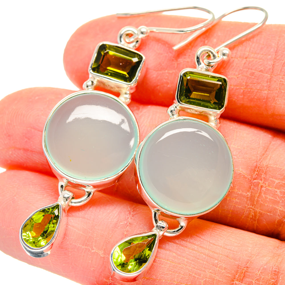 Sterling silver earrings with round pale green cabochons, peridot teardrop, and square stones