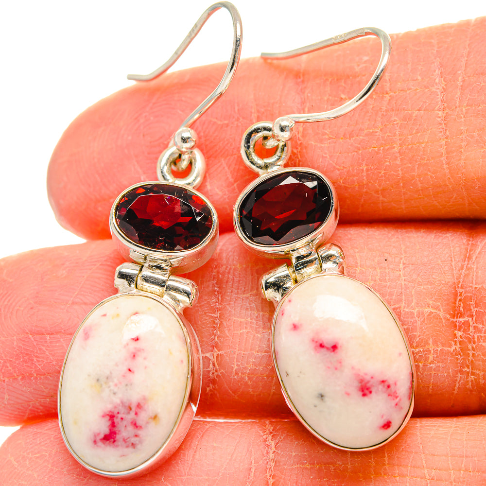 Sterling silver drop earrings with faceted red round stones and oval white-pink cabochons.