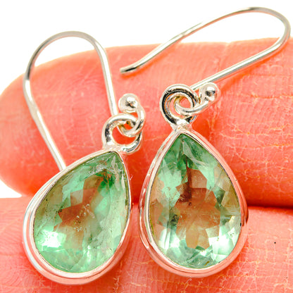 Green fluorite teardrop earrings in 925 sterling silver, close-up of faceted stone