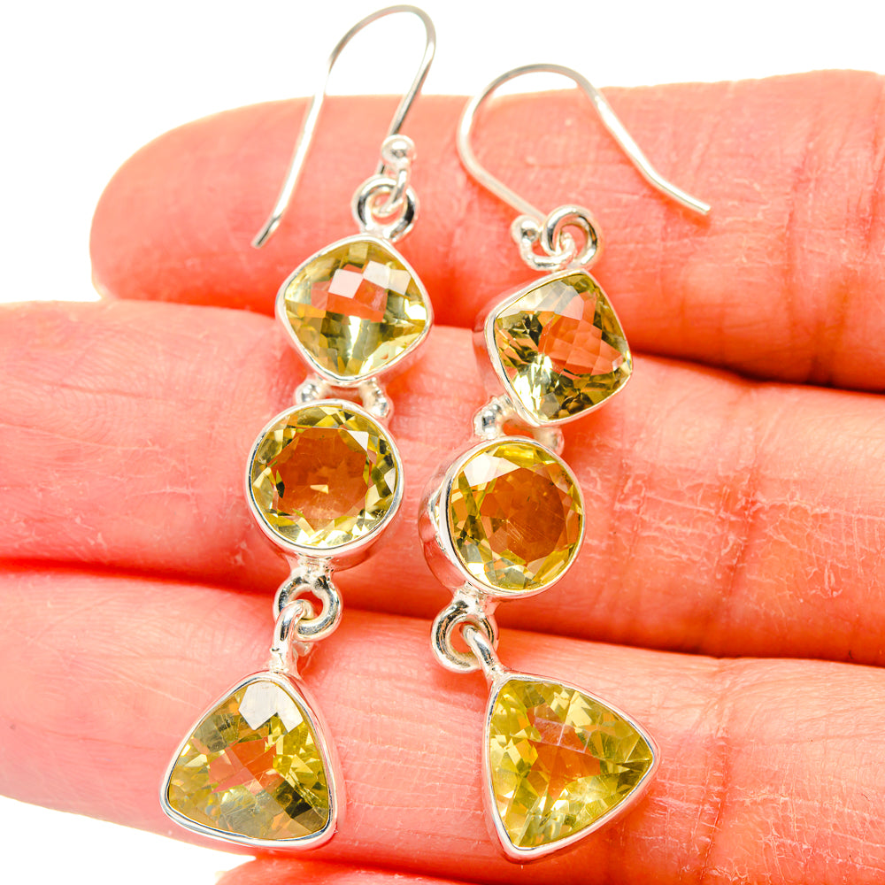 Sterling silver citrine chandelier earrings with round and teardrop yellow stones, close-up
