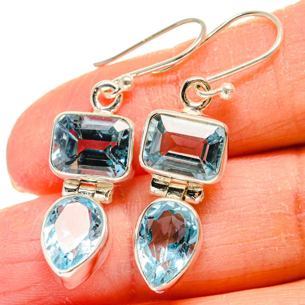 Blue topaz earrings close-up, square stones and teardrop dangles on 925 sterling silver hooks