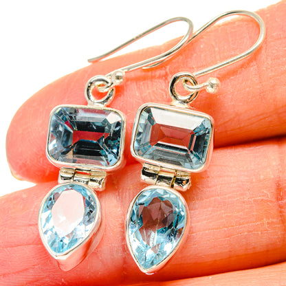 Blue topaz earrings close-up, square stones and teardrop dangles on 925 sterling silver hooks