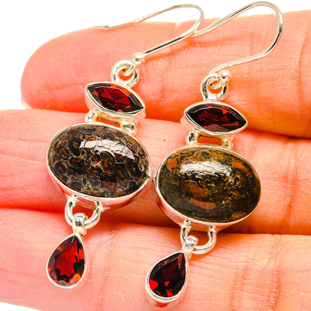 Sterling silver drop earrings with amber dinosaur-bone disc and red teardrop accents