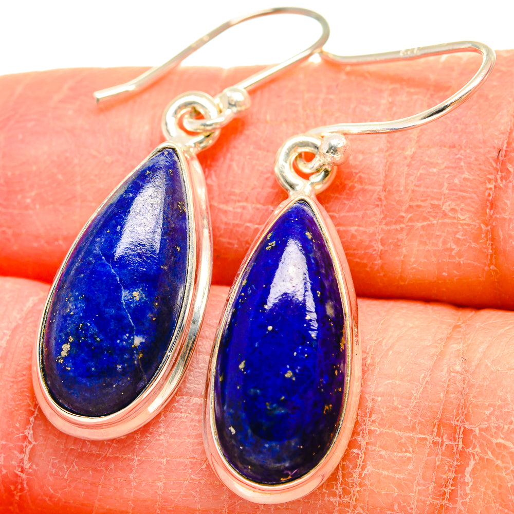Close-up: sterling silver lapis lazuli teardrop earrings with rich blue, speckled stone