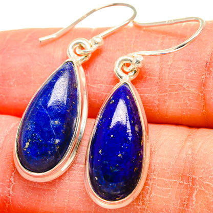 Close-up: sterling silver lapis lazuli teardrop earrings with rich blue, speckled stone