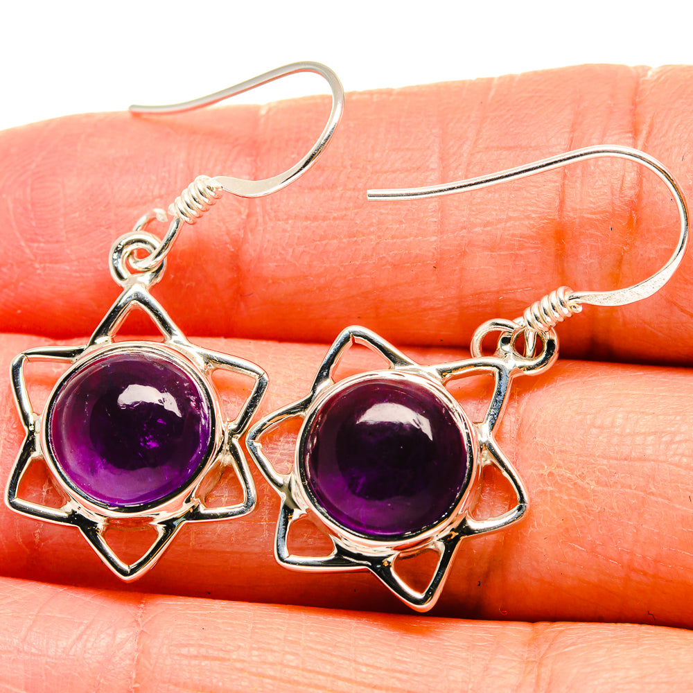 Round amethyst stones in star settings on 925 silver hook earrings, purple cabochons.