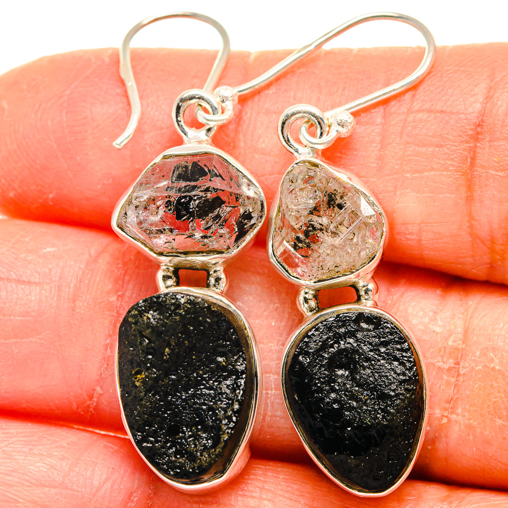 Sterling silver hook earrings with faceted red-speckled clear and black teardrop stones
