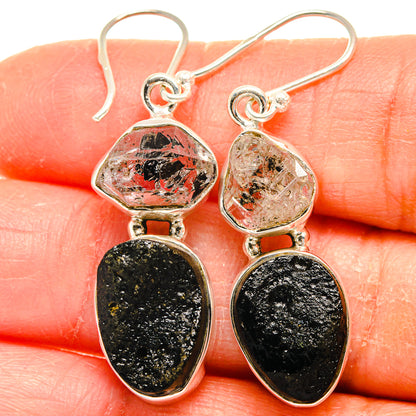 Sterling silver hook earrings with faceted red-speckled clear and black teardrop stones
