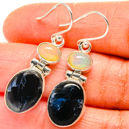 Sterling silver earrings with round yellow opal cabochons and oval dark blue-black stones