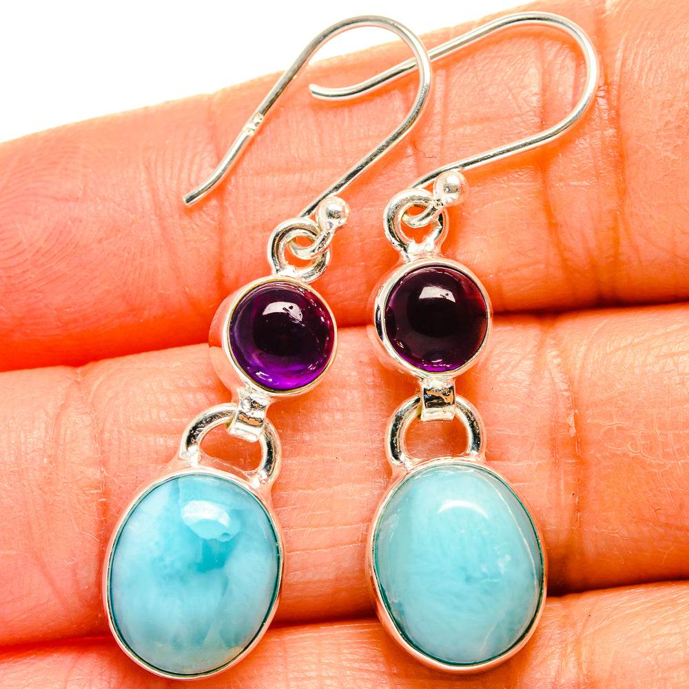 Silver drop earrings featuring purple round stones and light-blue oval larimar drops