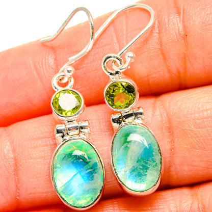 Sterling silver drop earrings close-up: peridot green round stones and oval moonstone