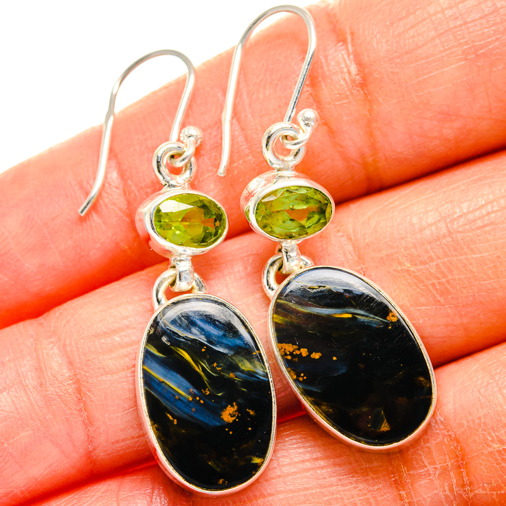 Sterling silver drop earrings with green peridot and dark blue oval pietersite