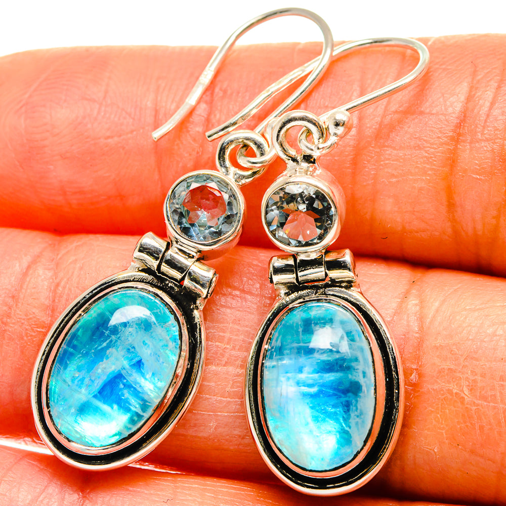 Sterling silver drop earrings with oval turquoise-blue stones and small round blue gems